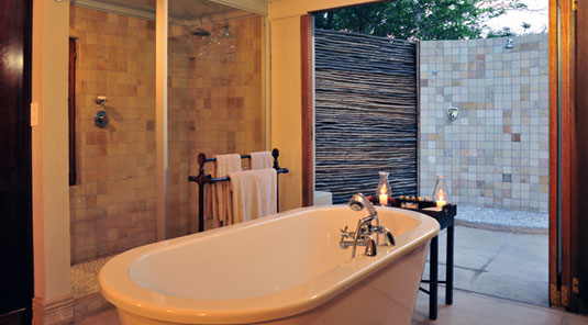 Luxury Suite's Bathroom and outdoor shower  at Savanna Private Game Reserve in the Sabi Sand Private Game Reserve. Luxury Safari Lodge Accommodation